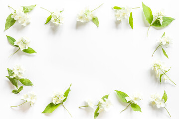 Frame of white jasmine flowers. Top view flat lay
