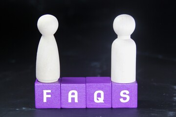 purple wooden cubes with the words FAQS or Frequently Asked Questions
