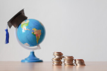 stack of cion with hat graduation on global model. Learning without borders.Studies lead to success in world wide. Education concept.back to school.