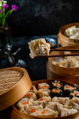 Assorted Chinese Dimsum in bamboo basket. Dimsum is a large range of small dishes that Cantonese people traditionally enjoy in restaurants for breakfast and lunch.