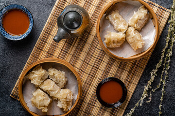 Assorted Chinese Dimsum in bamboo basket. Dimsum is a large range of small dishes that Cantonese people traditionally enjoy in restaurants for breakfast and lunch.