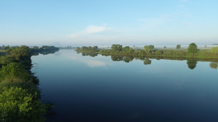 Aerial photography of morning fog over the river and floodplains