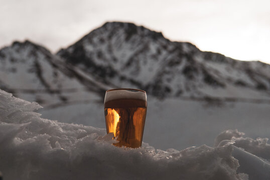 Beer on snow with mountain background. On Las Leñas