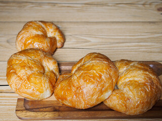 Top View Homemade croissants on wooden background.