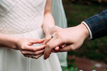 Wedding rings of the bride and groom in white gold. Ceremony