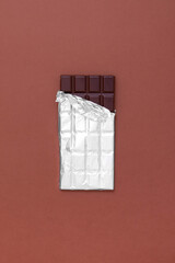 Open chocolate bar with aluminum foil