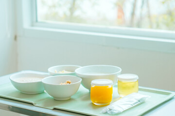 Food tray on the table in a room of a hospital. Patient and hospital concept. Copy space.  - obrazy, fototapety, plakaty