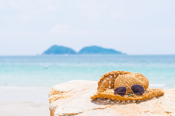 Fototapeta na wymiar Closeup of summer beach and straw hat on beach.