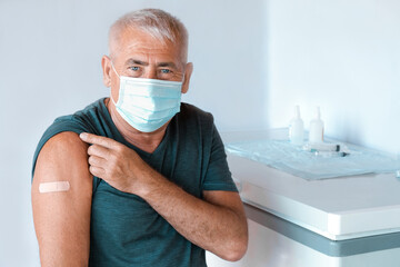 Male Senior in Face Mask after Receiving COVID-19 Vaccine. Elderly Man feeling Good on getting...