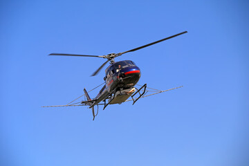 Agricultural helicopters for controlling Hyphantria cunea spray pesticides over the city