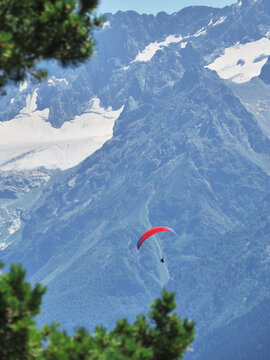 Paraglider flying through the mountains