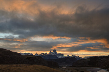 The road approaching the town of El Chalten with famous Patagonia mountains in the background at golden hour