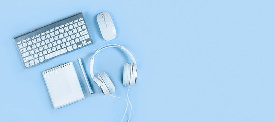 Wide banner on a pink background, flat layout, keyboard, headphones, notebook, smartphone. Concept - home office, online education, webinars, seminars, blogging training