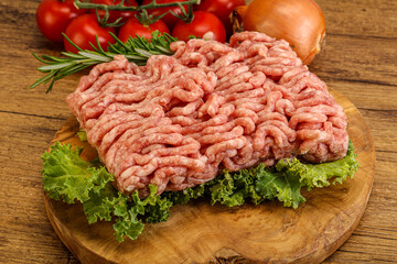 Raw pork minced meat over board