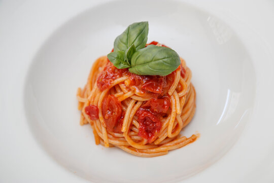 Fine lunch italian restaurant dish, detail is close to a dish with spaghetti al pomodoro.