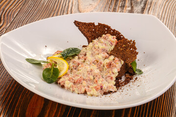 Tartar with beef meat served lemon