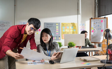 Obraz premium Businessman creative designers present their work to the team. Designers are meeting in a modern office.