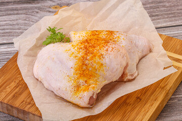 Raw chicken thigh with spices