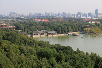 Beijing Summer Palace and modern urban landscape in the distance, China