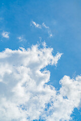 Blue sky with beautiful natural white clouds. Space for text. Background.