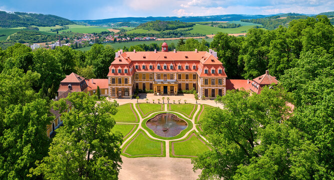 Aerial view of classicist chateau of French style. Large chateau, built by Salm noble family, surrounded by park, trees and hills. Summer, R&aacute;jec nad Svitavou, traveling Czech republic.