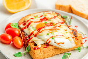 Fried Egg on toasted bread,Tomatoes breakfast.Tasty morning food.