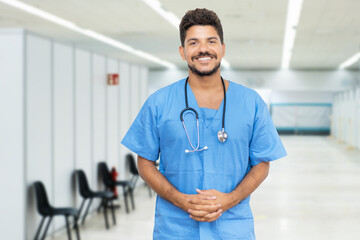Young hispanic male doctor is ready for vacinating patients