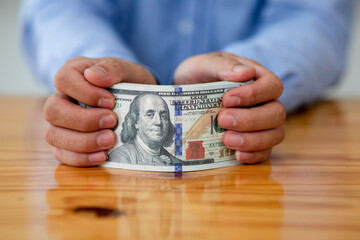 Business man hands counting US Dollar bills or paying in cash .