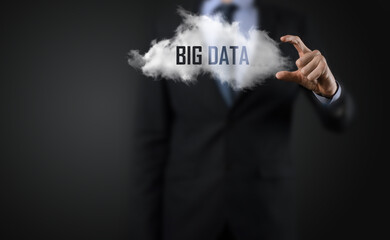 Hand showing a cloud with the words big data on dark background.
