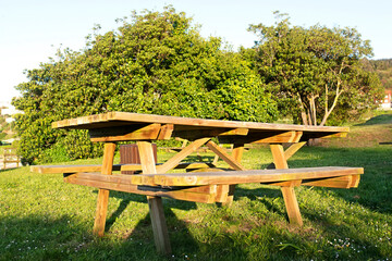 picnic area with  empty wooden tables , background
