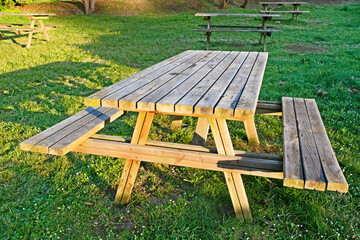 picnic area with  empty wooden tables , background