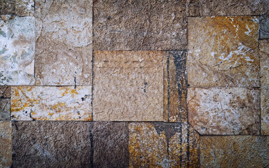 square cut stone wall closeup, natural material rough background