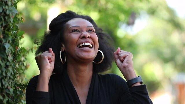 Black woman celebrates success. happy African person feeling ecstatic, great news