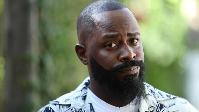 Skeptical African man being doubtful. Puzzled black person