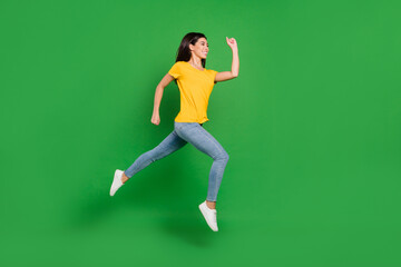 Fototapeta na wymiar Full size profile side photo of charming pretty young woman jump up run empty space isolated on green color background
