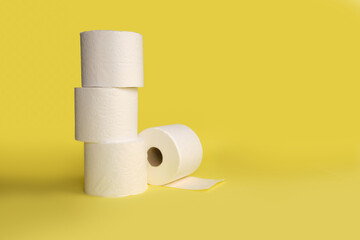 Rolls of toilet paper on color background