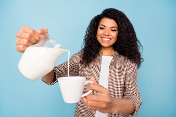 Photo of shiny adorable dark skin lady wear plaid shirt drinking milk beverage smiling isolated...
