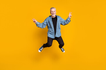 Fototapeta na wymiar Full length photo of funky grandpa jump show v-sign wear jacket pants sneakers isolated on yellow color background