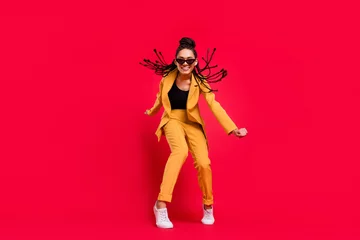 Poster Full body photo of cool lady dance wear eyewear yellow suit isolated on vivid red color background © deagreez