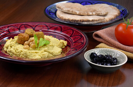 Chickpea hummus with falafel close-up stock images. Traditional homemade hummus served with pita bread still life stock images. Delicious Middle Eastern cuisine photo