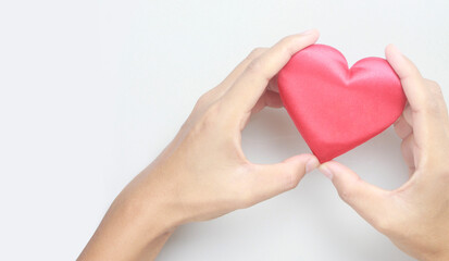 Obraz premium Hands holding red heart. heart health donation concepts