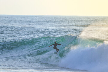 Surfer on Blue Ocean Wave . Surf spot in Ericeira Portugal.	