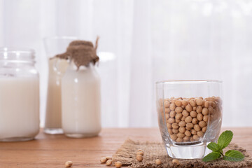wood table with soybean and milk.