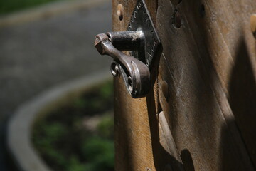 Open antique door, old wooden entrance door with antique door handle.