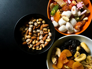 Dried fruits and Turkish delight with nuts mix on a black table background. And also its a very healty food