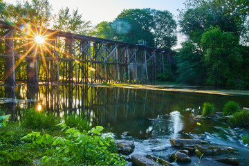 Old wooden railroad bridge over water