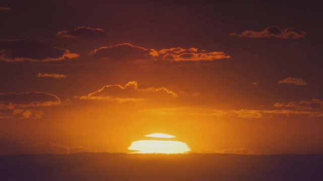 African sunset time lapse with big sun and backlit clouds. Cinematic 4k footage.