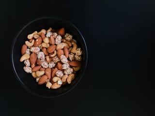 Dried fruits and Turkish delight with nuts mix on a black table background. And also its a very healty food