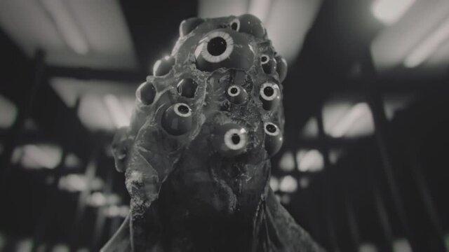 Black and white vintage sci-fi alien creature with many glowing eyes. Beholder. Mutant.