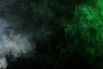 Artificial smoke in grey-green light on black background